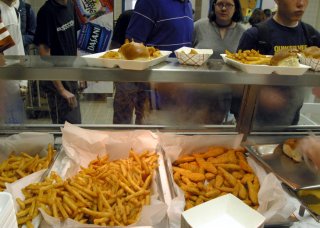 3076153-students-line-up-to-receive-food-during-lunch-in-the